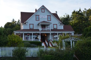 Julie barely visible as she enjoys the evening light from the historic Orcas Hotel