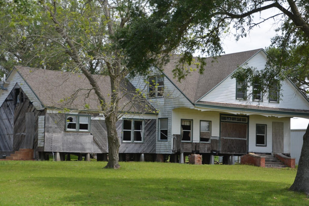 A boarded up old house on the bayou, probably beautiful in its day, damaged by Katrina but still standing