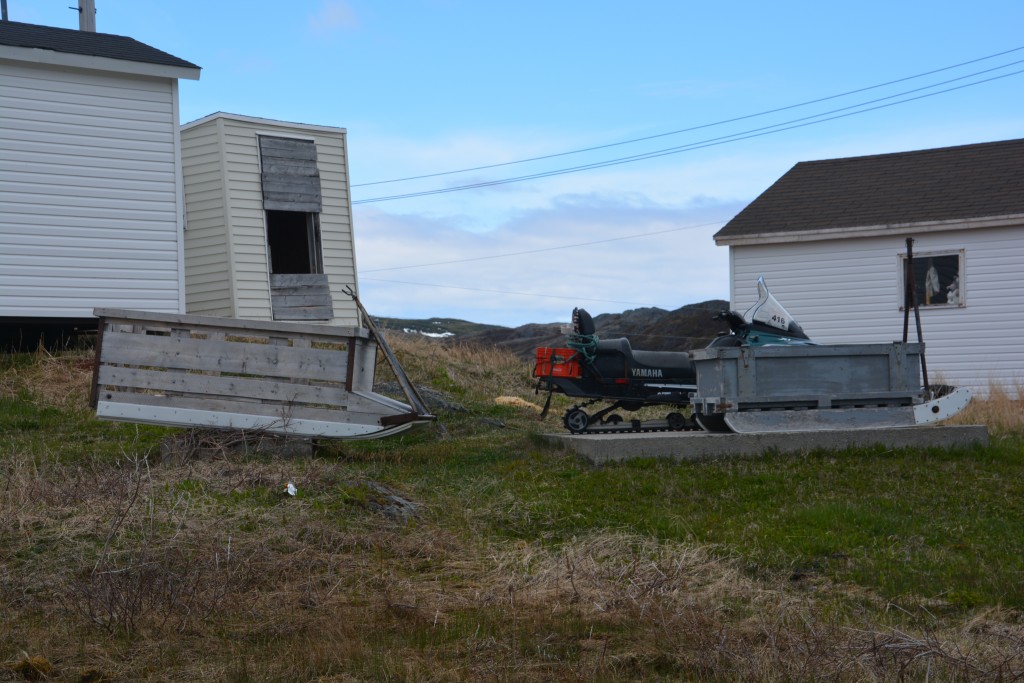 These are two of the outstanding features in any local home's front yard - a snowmobile and a sled that they use in the winter to carry goods