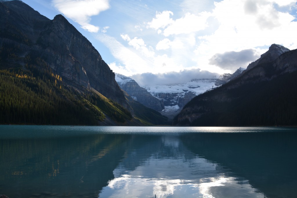 Famous Lake Louise with the sun low on the sky behind Victoria Glacier